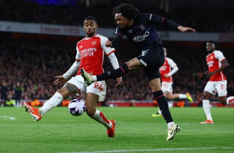 Arsenal's Reiss Nelson attempts to block a cross by Luton Town's Tahith Chong.
