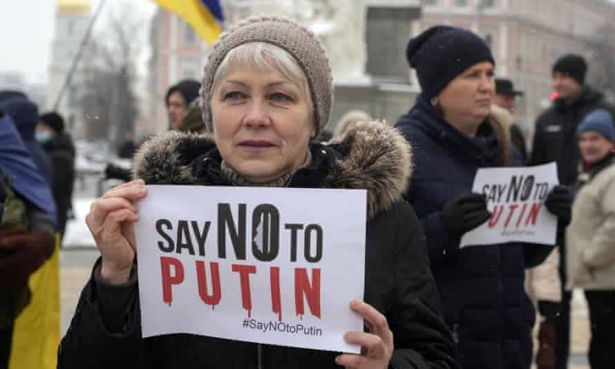 Activists hold posters during a Say NO to Putin rally in Kyiv on 9 January.