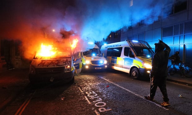 A police van on fire outside Bridewell police station on 21 March