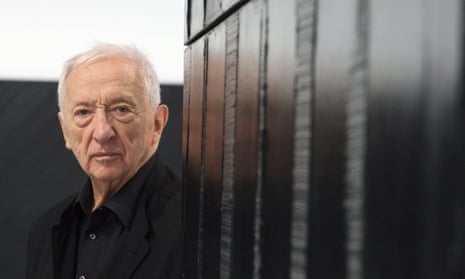 Pierre Soulages with one of his works at the Pompidou Centre in Paris, 2009. He created complex textures on canvases flooded with black, combining areas of smoothness and roughness and digging deep lines into the thick, layered paint.