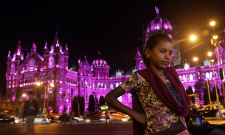 International Women’s Day in Mumbaiepa05834729 An Indian girl stands in front of the Chhatrapati Shivaji Maharaj Terminus (CSMT) railway station, lit up in pink colour on the eve of International Women’s Day, in Mumbai, India, 07 February 2017. International Women’s Day is celebrated globally on 08 March to promote women’s rights and equality. EPA/DIVYAKANT SOLANKI