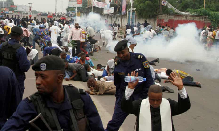 Riot police fire teargas to disperse a Catholic priest and demonstrators during a protest against President Joseph Kabila in Kinshasa in January.
