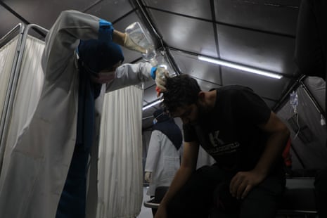 An injured man is treated at a temporary clinic in Rafah on Wednesday.