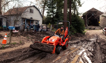 Darren Sauter volunteers to help clear mud and debris from neighborhoods hit hard by California’s storms.