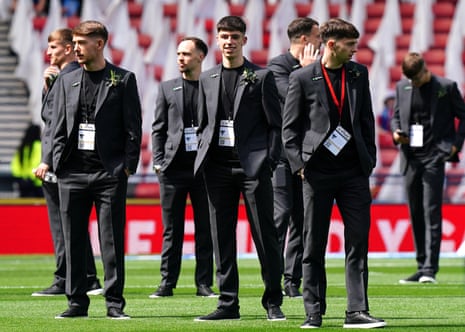 Dunfermline Athletic’s suited and booted players inspect the Hampden Park pitch.