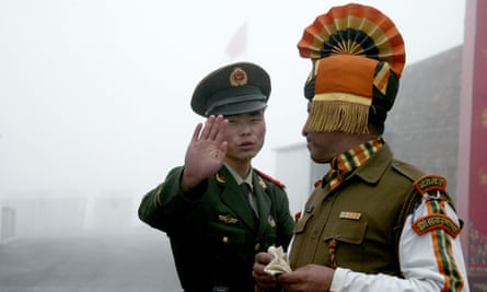 This 2008 image shows a Chinese soldier and an Indian soldier at the Nathu La border crossing.
