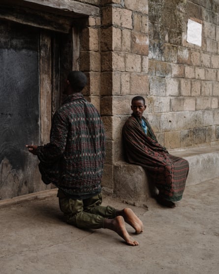 Two people in front of brick wall