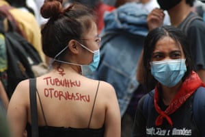 A slogan on an activist’s back reads: “My body, my authority”, in Bandung, Indonesia