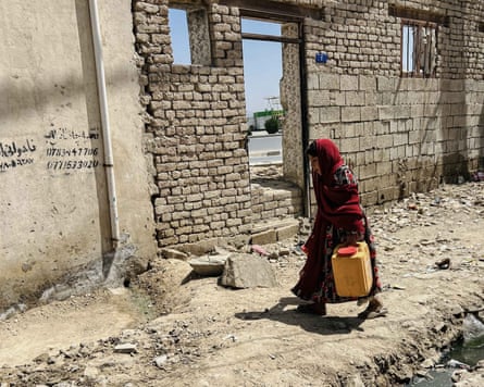 An Afghan girl carries drinking water in Kabul, Afghanistan, in August 2025.