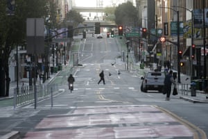 A man crosses a nearly empty street in San Francisco on Tuesday.