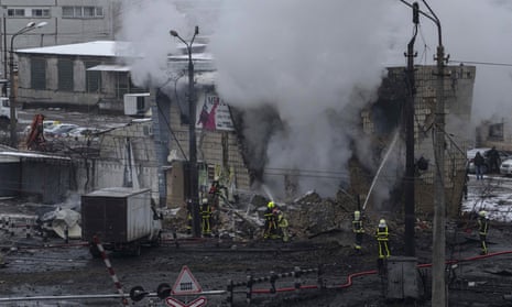 Firefighters work to extinguish a fire after Russian rocket attack in Kyiv.