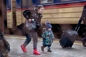 A woman with a young child seen on a platform of the arrival train from Ukraine at Przemyśl Główny train station in Poland.