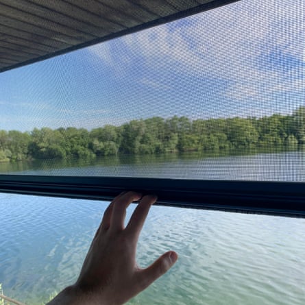Hand operating window with flyscreen at a lakeside property.