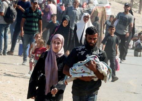 Displaced Palestinian people move southward after Israeli forces ordered residents of Gaza City to leave.