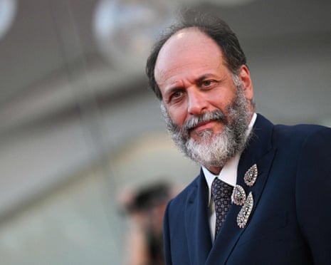 Man in suit looks towards camera