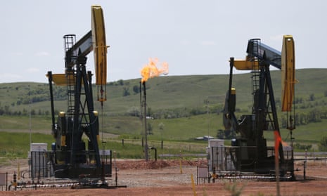 Natural gas (methane) is burned off near pumps in Watford City, North Dakota. The Trump administration is seeking to roll back regulations on methane leaks from oil and gas facilities.