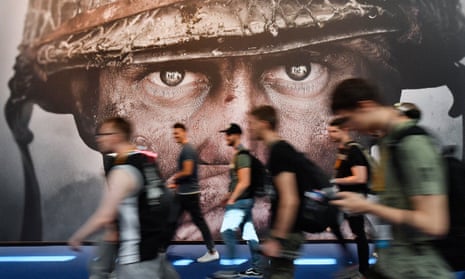 Visitors pass an advertisement for the Activision Blizzard video game Call of Duty at a computer games fair in Cologne, Germany