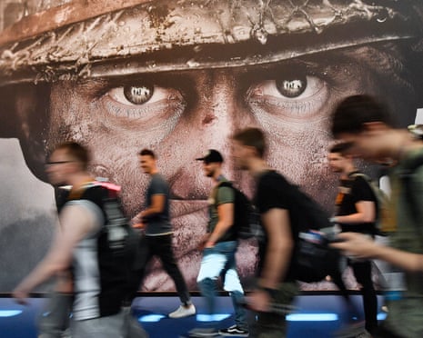 Visitors pass an advertisement for the Activision Blizzard video game Call of Duty at a computer games fair in Cologne, Germany