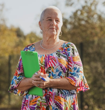 Sue Elias, a woman with short white hair, in a floral dress, holding a green clipboard as she gathers signatures in a campaign against the building of a datacentre in east Cardiff, Wales
