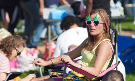 Woman sitting and smoking wearing cannabis-leaf sunglasses
