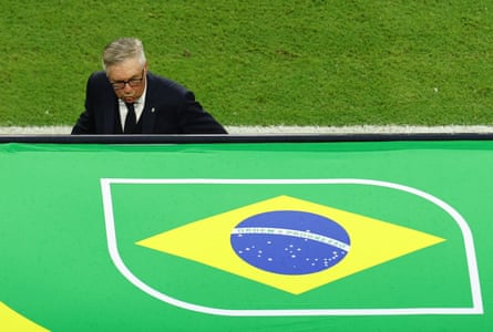 Carlo Ancelotti takes shelter in the Brazil dugout