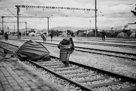 A boy carries his belongings on the day the Greek military began evicting people from the Idomeni refugee camp