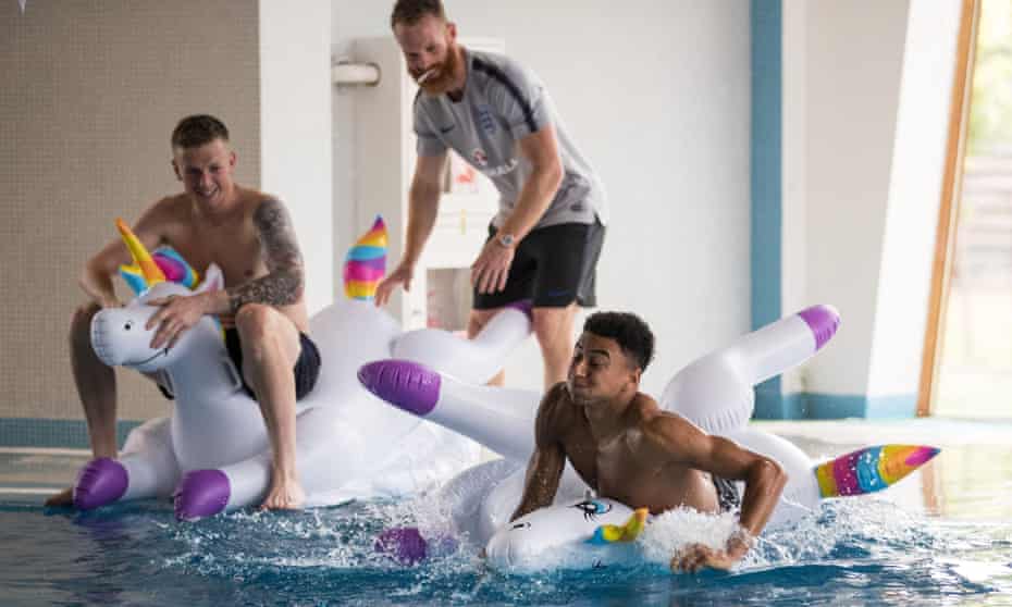 Jesse Lingard is pushed into a swimming pool by a member of the coaching staff at England’s World Cup base in Repino. 