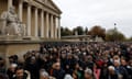 Demonstrators pass the French Assemblée National on a march against antisemitism