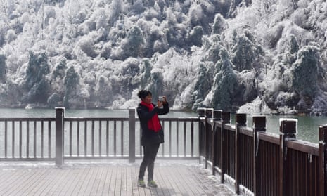 A woman photographs the scene at Hangzhou, in eastern China’s Zhejiang province.