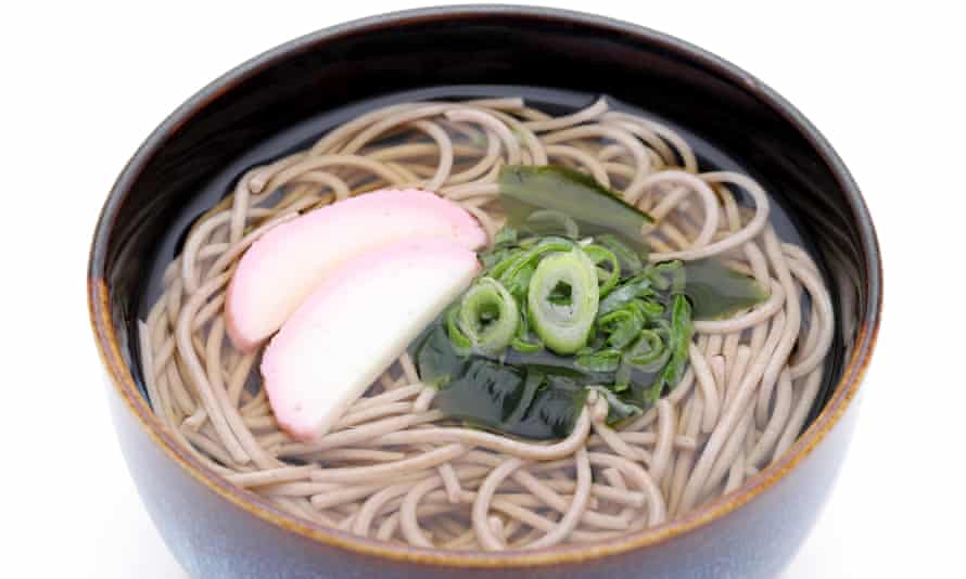 Japanese Kake soba noodles in a ceramic bowl.