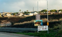 Signs asking people to respect locals and that 'Lahaina is not for sale' are seen on the side of the Lahaina Bypass, in Lahaina, Hawaii.