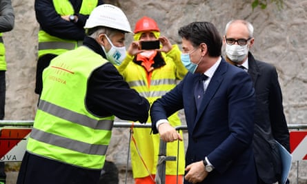 The Italian prime minister, Giuseppe Conte (R), greets Genoa’s mayor, Marco Bucci