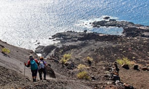 Women walking the lava fields and coast of El Hierro, Canary Islands, Spain.