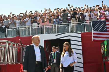 Donald Trump and his granddaughter Kai Madison Trump appear before the fervent crowds at Bethpage Black on Friday.