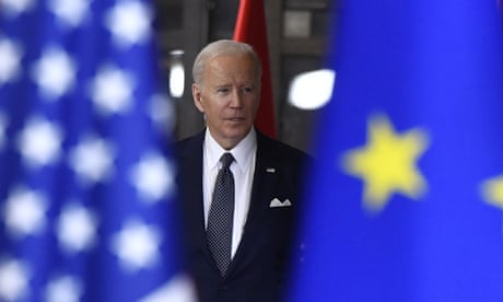 President Joe Biden surrounded by flags