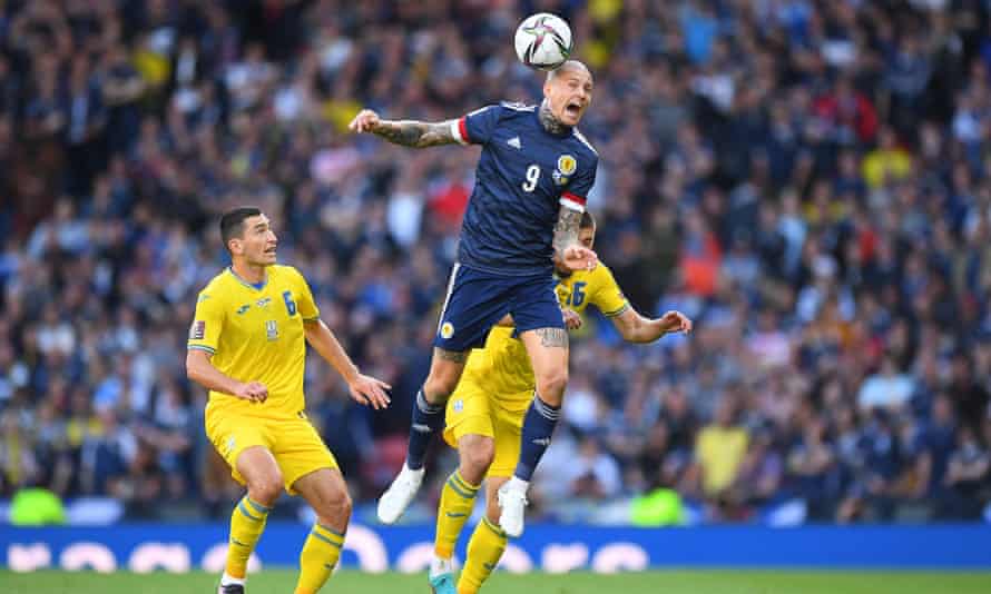 Scotland striker Lyndon Dykes wins a header against Ukraine