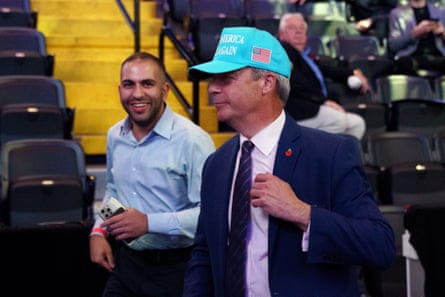 Nigel Farage in a blue cap with a US flag on it