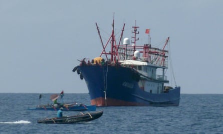 Filipino fishers sailing past a Chinese vessel in the Scarborough Shoal, in the disputed South China Sea.