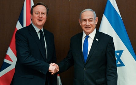 Cameron shakes hands with Netanyahu standing before the union flag and the Israeli flag