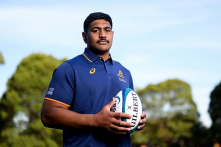 Will Skelton poses for a photo holding a rugby ball