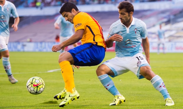 Luis Suarez of FC Barcelona controls the ball next to Jonny Castro Otto of Celta Vigo.