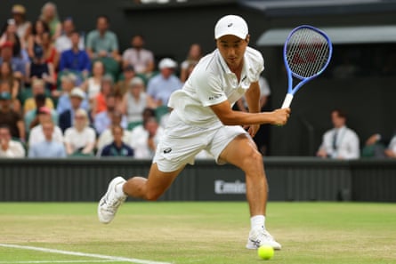 Shintaro Mochizuki stretches to play a shot