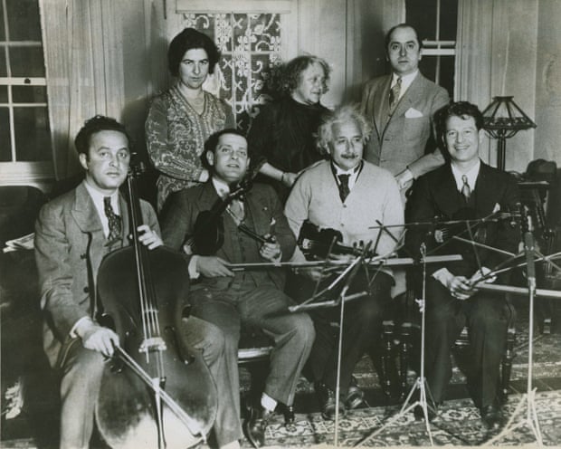 Einstein and the other members of the string quartet gather to practice for a concert at the Waldorf-Astoria Hotel (concert date: December 15, 1933) to raise money for German Jewish refugees.  From left to right, seated: Arthur (Ossip) Giskin, Toscha Seidel, Albert Einstein and Bernard Ocko;  standing: Mrs. Seidel, Elsa Einstein and an unidentified man.