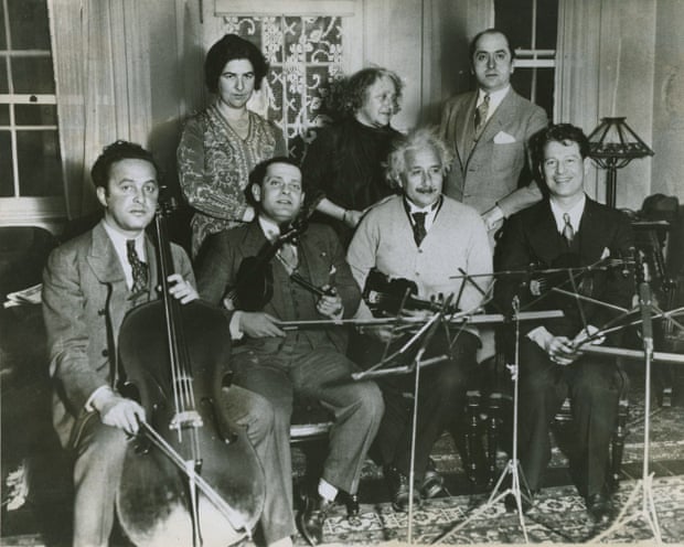 Einstein and the other members of the string quartet gather to practice for a concert at the Waldorf-Astoria Hotel (concert date: December 15, 1933) to raise money for German Jewish refugees. From left to right, seated: Arthur (Ossip) Giskin, Toscha Seidel, Albert Einstein and Bernard Ocko; standing: Mrs. Seidel, Elsa Einstein and an unidentified man.