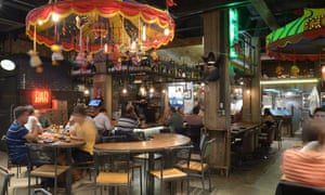 Customers at tables near the bar in the A Casa do Porco restaurant in Sao Paulo, Brazil.