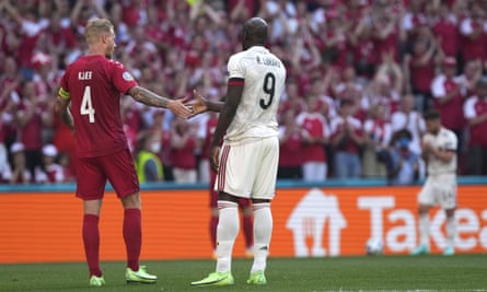Denmark captain Simon Kjær shakes hands with Belgium’s Romelu Lukaku as the players stop play after 10 minutes in tribute to Christian Eriksen.