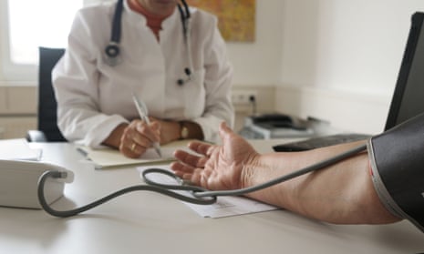 A doctors tests blood pressure