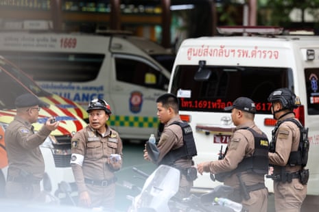 Police officers stand in the yard of Debsirin Nonthaburi School following the school shooting.