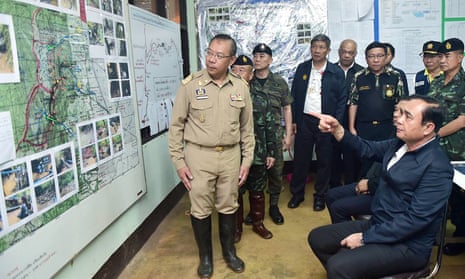 Thai Prime Minister Prayut Chan-o-cha is shown a map of the Tham Luang cave area
