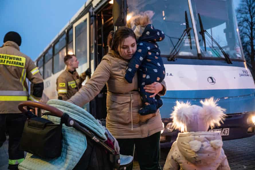 Ukrainian families depart from a coach at a shopping centre at Hala Kijowska, Poland.